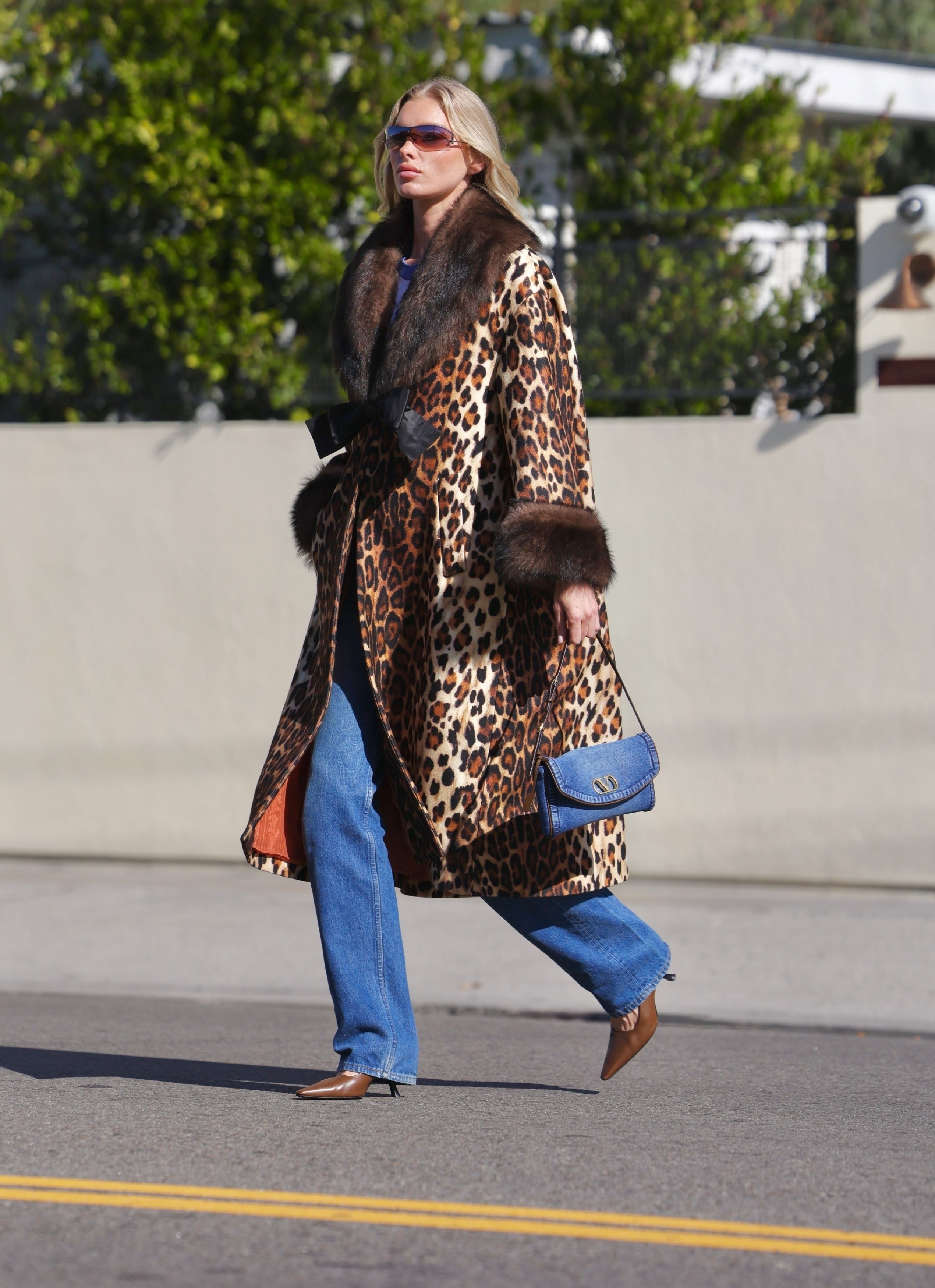 Elsa wears a leopard coat, valentino denim bag, jeans, and brown heels