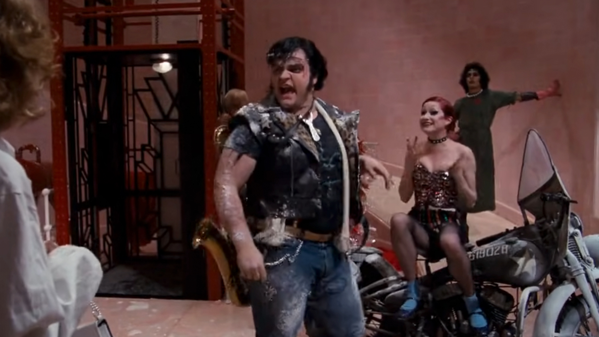 Meatloaf and other cast members singing in The Rocky Horror Picture Show.