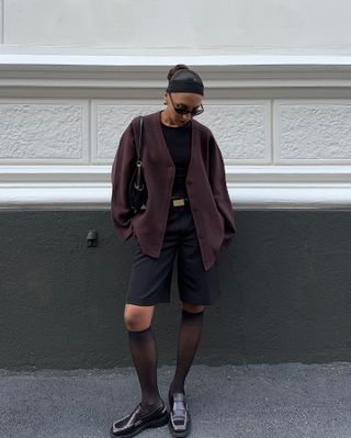 Fashion influencer @ingridedvinsen wearing a chic outfit styled with the shorts and tights trend.