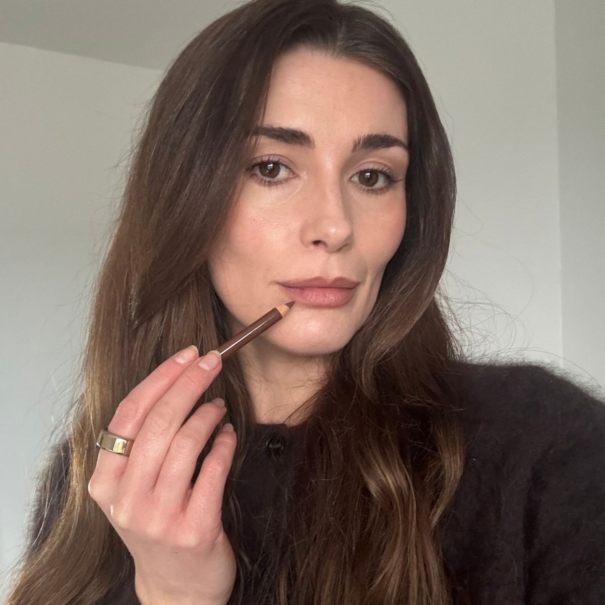Eleanor Vousden applying lip liner to her lips