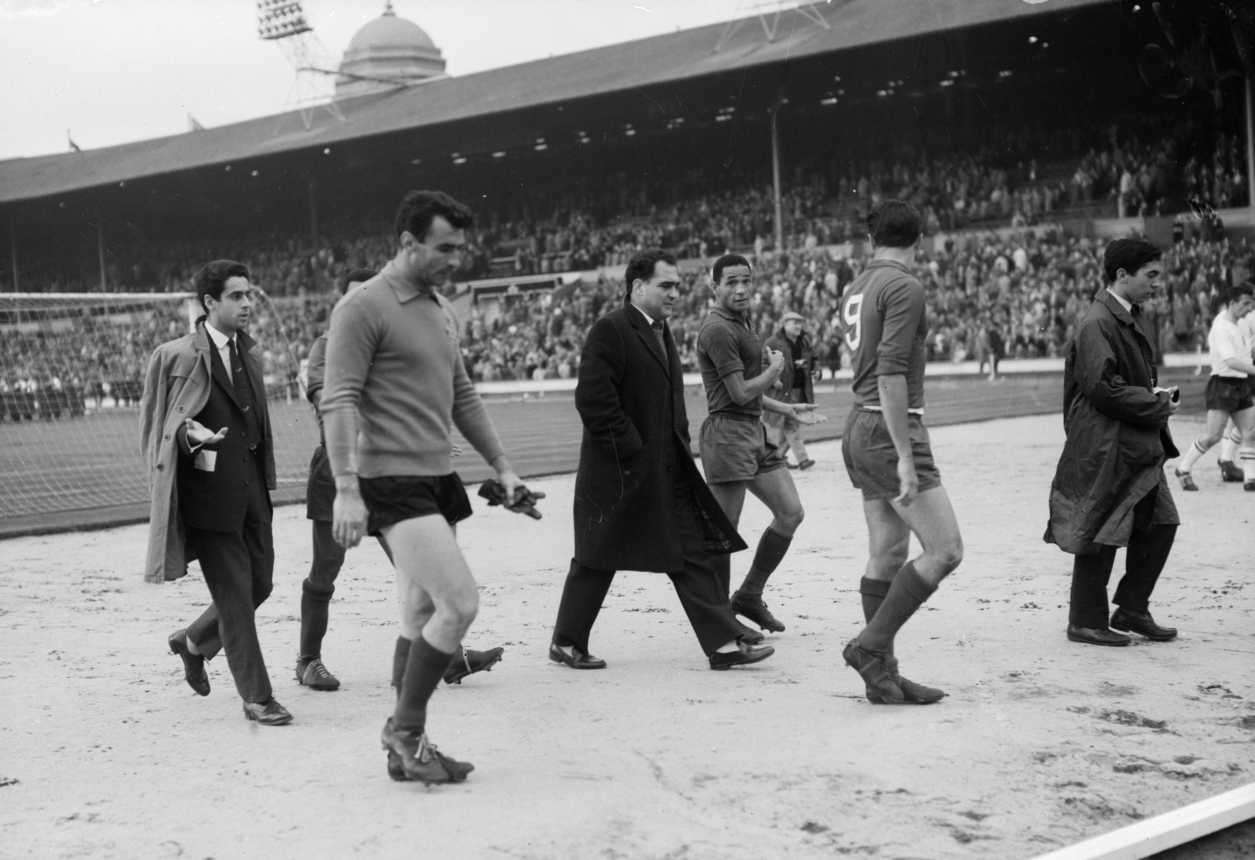 Portugal coach Fernando Peyroteo (centre) speaks with his players after a defeat at Wembley in October 1961.