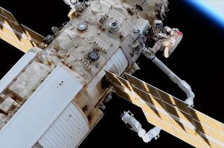 Russian cosmonaut Oleg Artemyev is seen on a spacewalk as the new European Robotic Arm (ERA) makes its first moves outside of the Nauka multi-purpose science module at the International Space Station on Thursday, April 28, 2022.