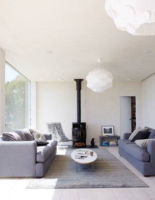 White living room with dark sofas