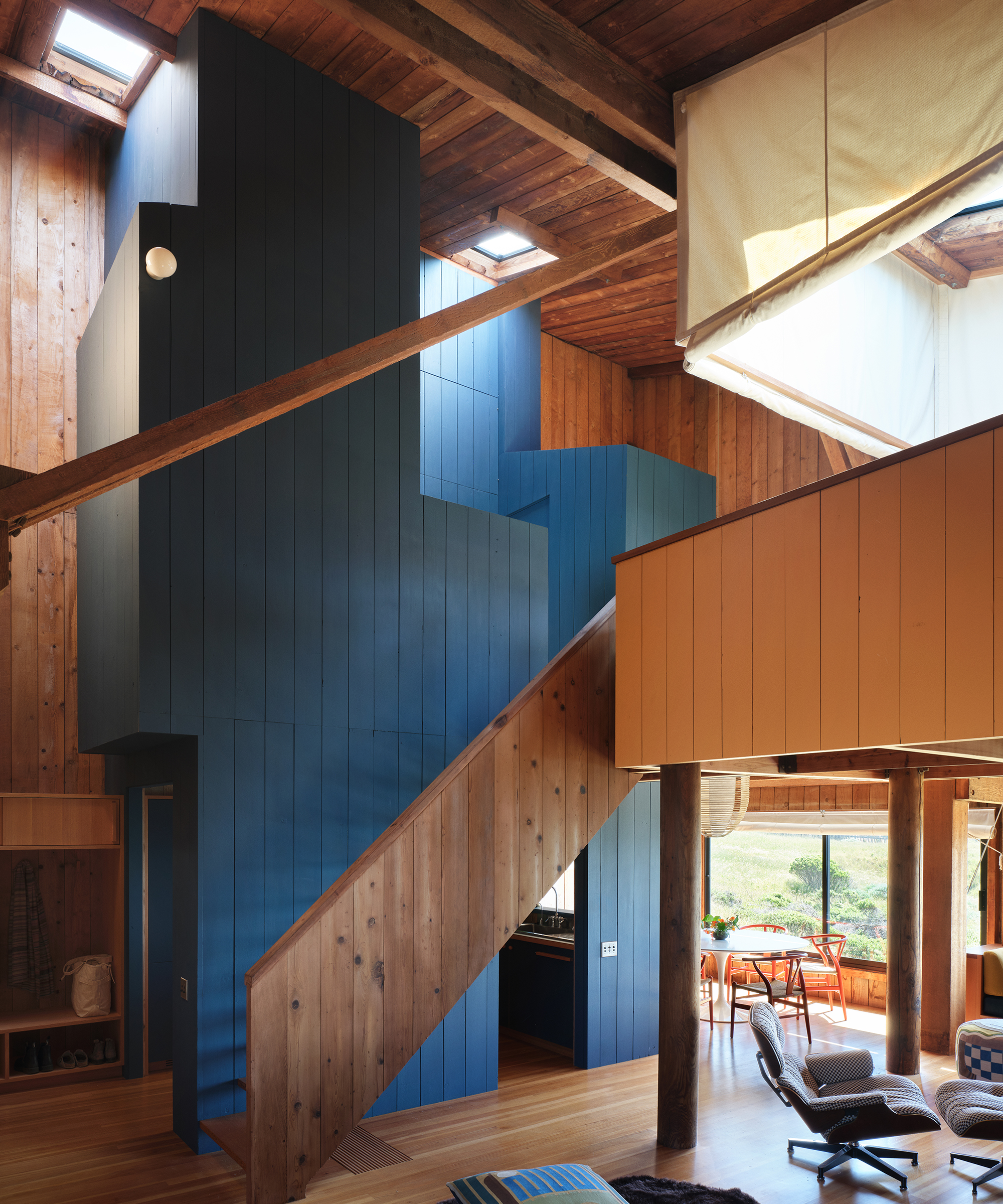 wood staircase leading up to triple height mezzanine level