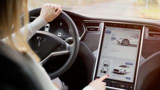 A woman navigating the Tesla Model S interior