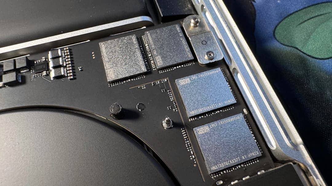 A MacBook Pro's mainboard showing replacement storage chips.