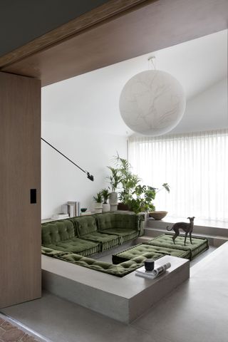 A living room with a sunken sofa