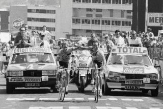 Bernard Hinault and Greg Lemond smile as they cross the finish line together on stage 18 of the 1986 Tour de France