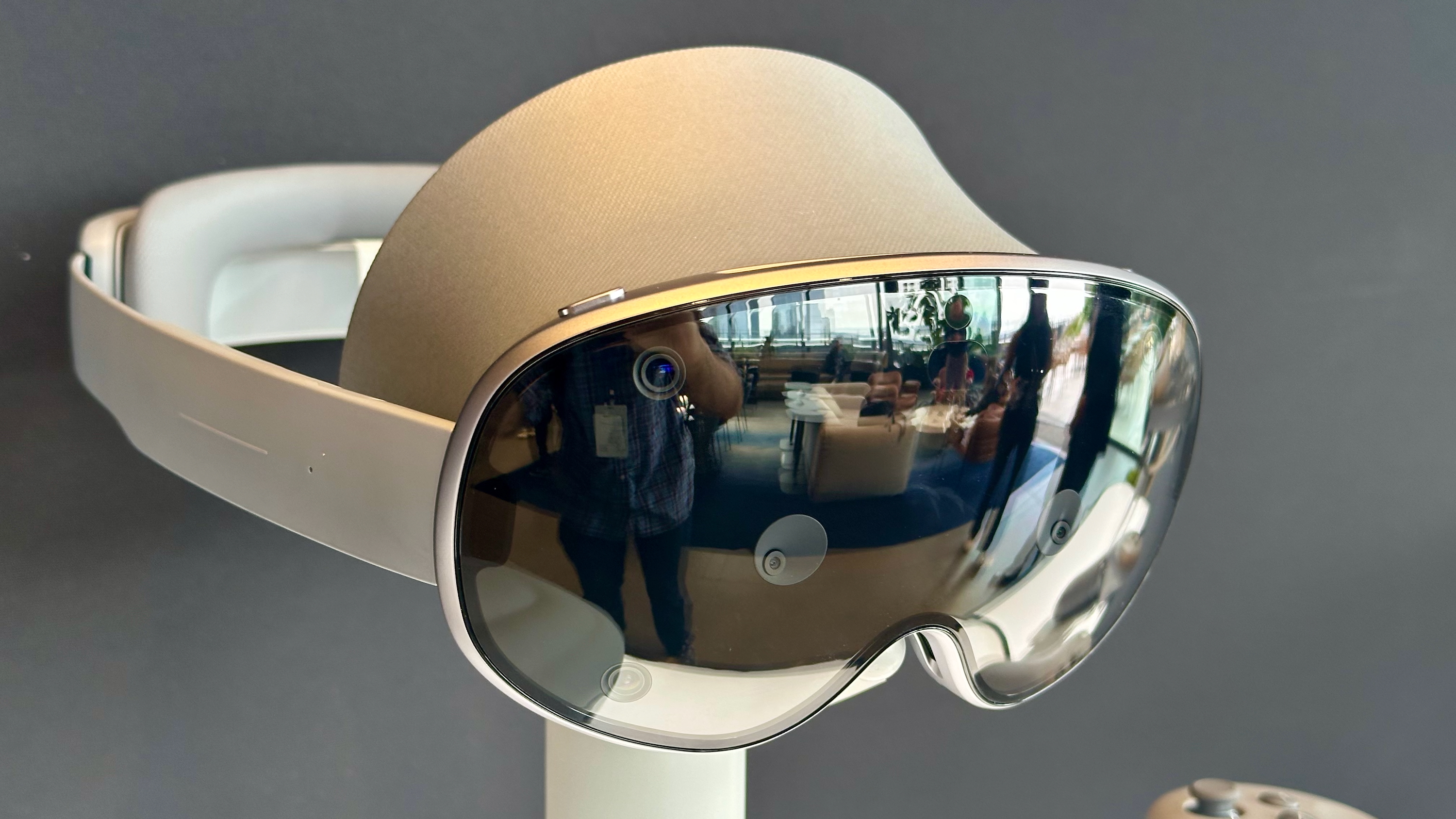 A close-up photo of the Samsung Galaxy XR headset sitting on a pedestal, angled to the front-right.