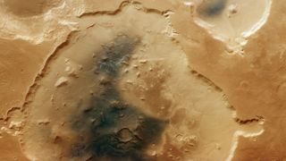 The nearly circular 75-mile-wide (120 kilometers) Deuteronilus Cavus crater lies in a transitional zone between Mars' rugged southern highlands and smoother northern lowlands.