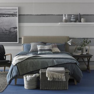 bedroom with cushions on bed and blanket with basket