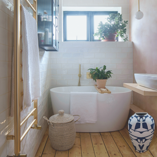 freestanding bath with houseplant. Tiled walls, wooden floorboards and textured walls