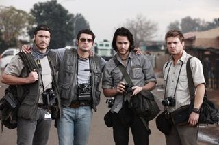Four men holding cameras