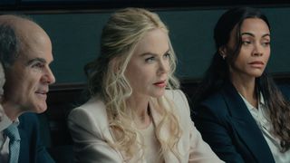 Byron, Kaitlyn and Joe look at someone across the table