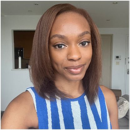 a person with brown hair wearing a blue and white dress
