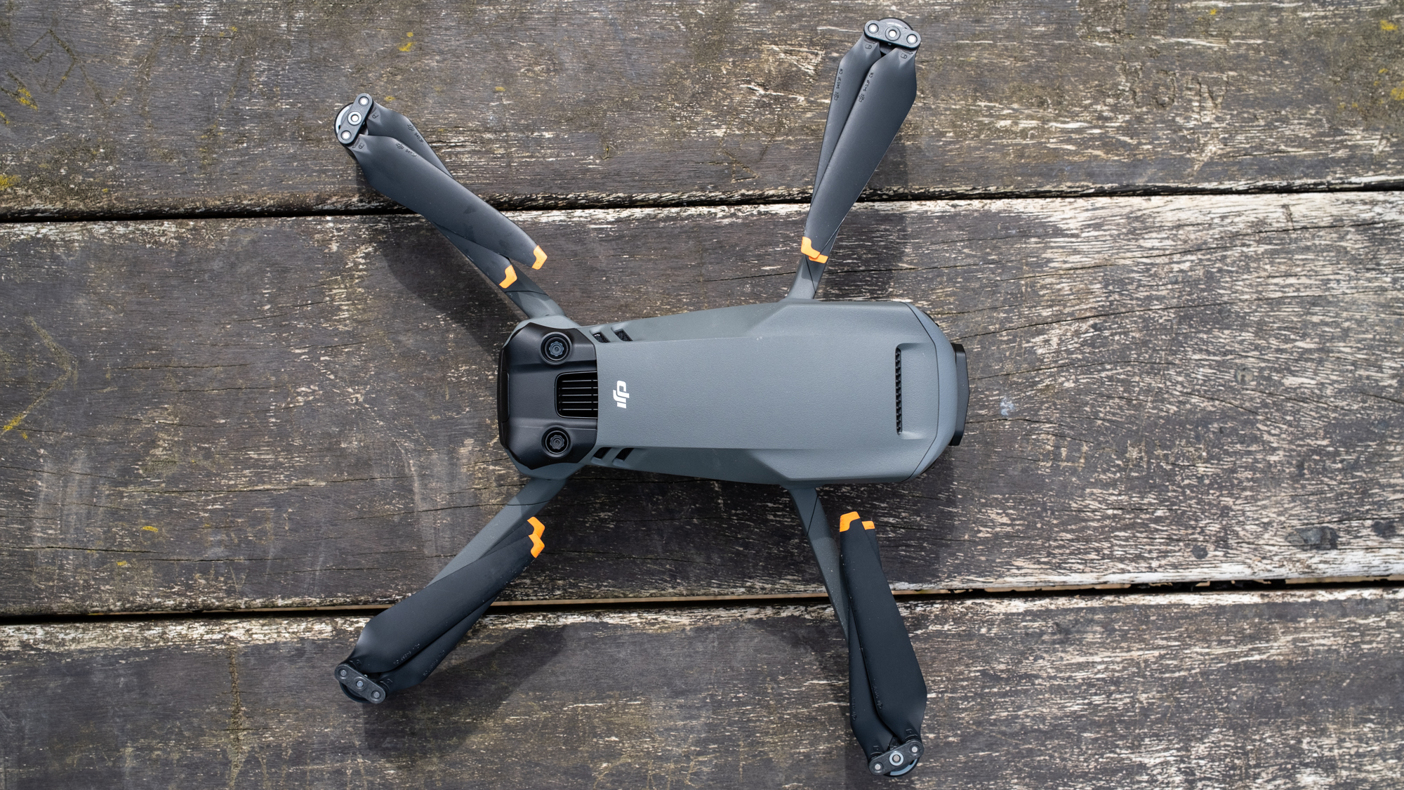 DJI Mavic 3 Pro drone on a wooden table with arms folded out