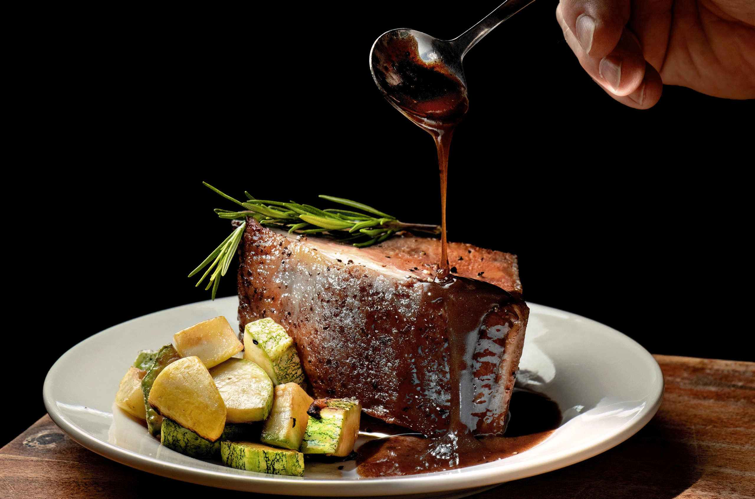 Serving of beef at a restaurant with gravy and vegetables
