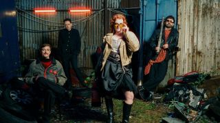 Sprints stood in front of a fence at night