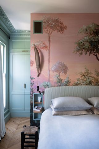 Pink and green mural behind bed, green wall colour