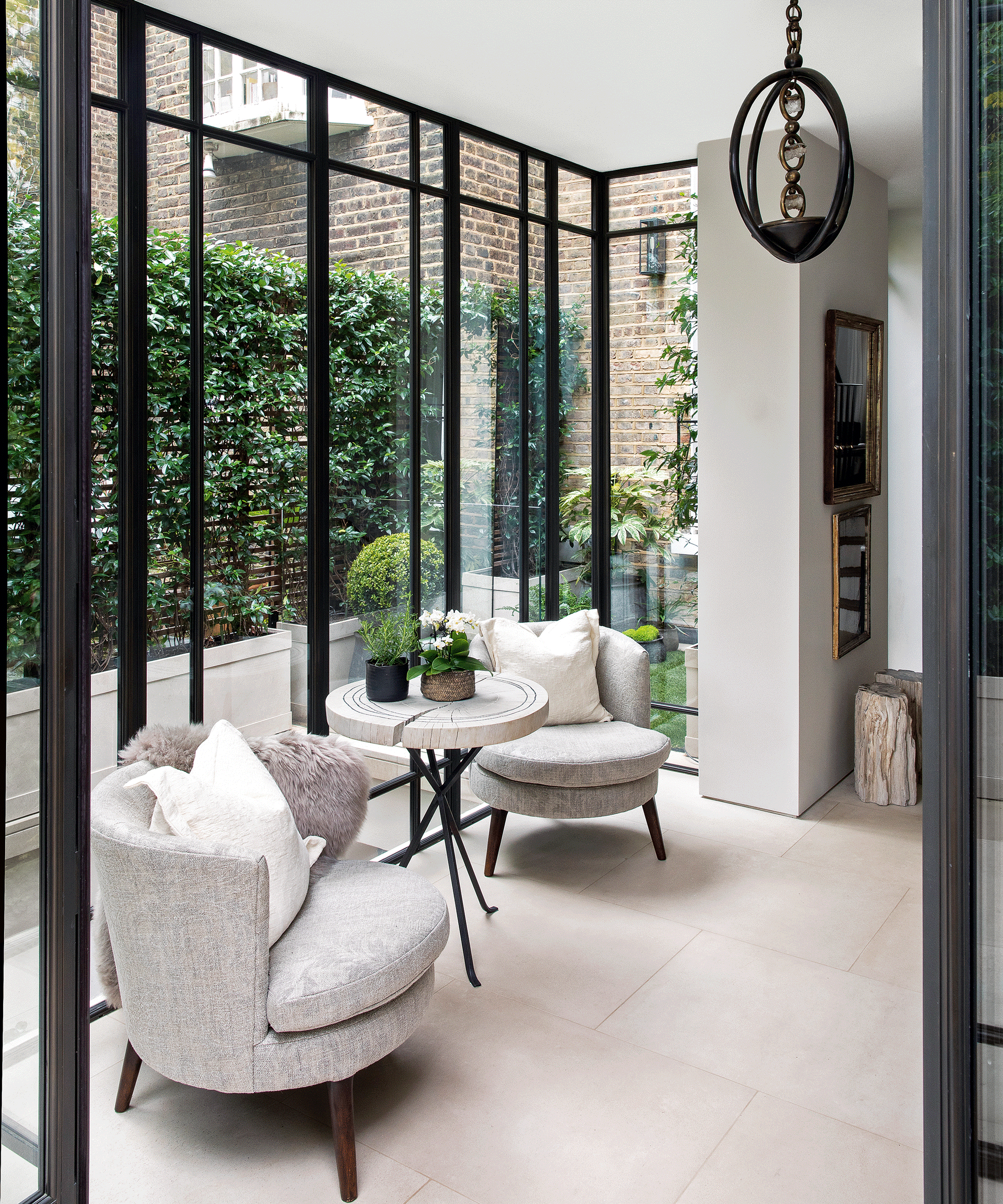 seating area with two chairs in glass walled room