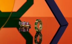 Two rings with coloured stone inlays against an orange background