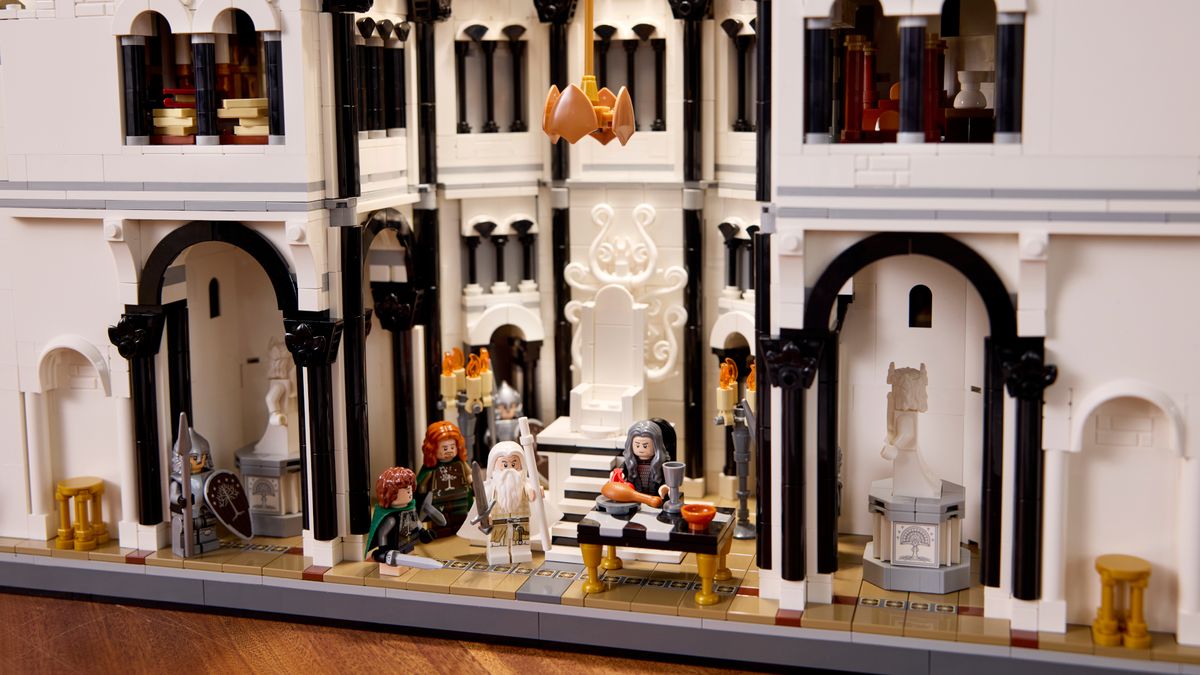 Lego Minas Tirith on a wooden surface, with multiple minifigures visible