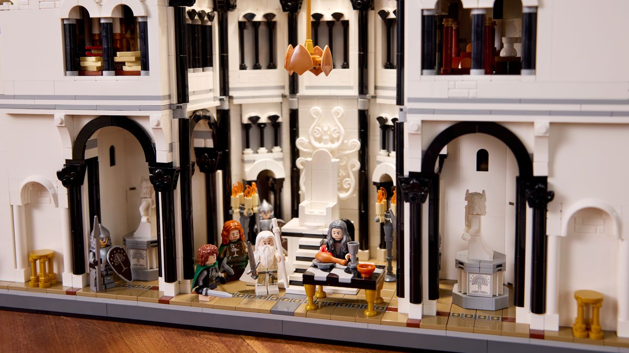 Lego Minas Tirith on a wooden surface, with multiple minifigures visible