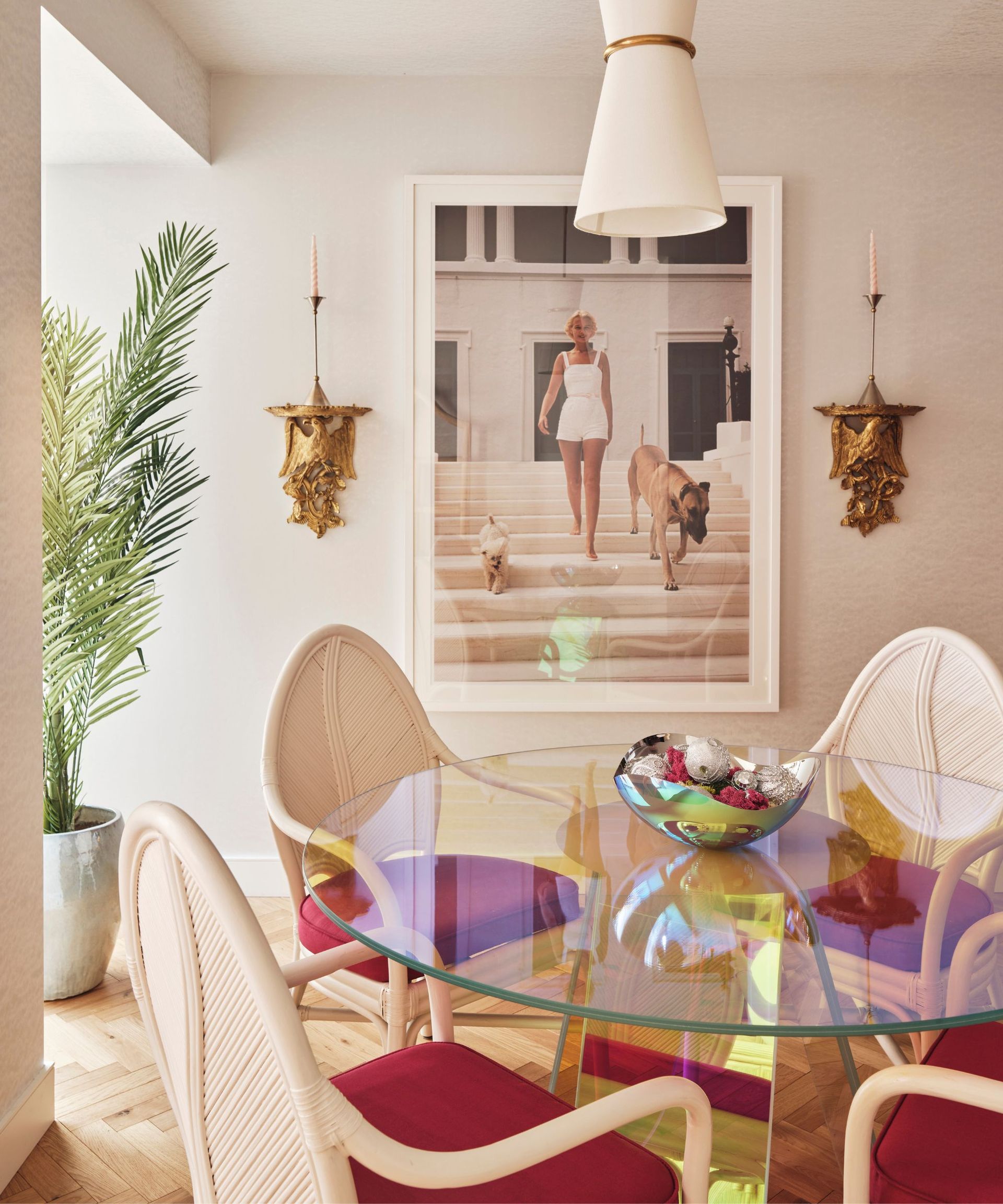 Gold candleholders, red cushioned chairs
