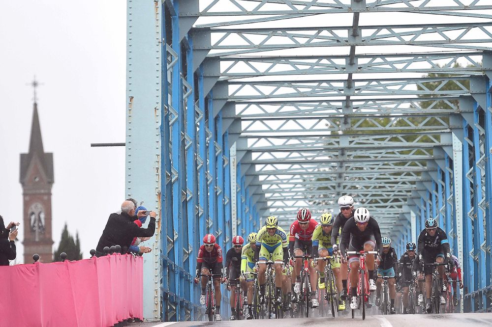 The peloton goes over a bridge durng stage 13.