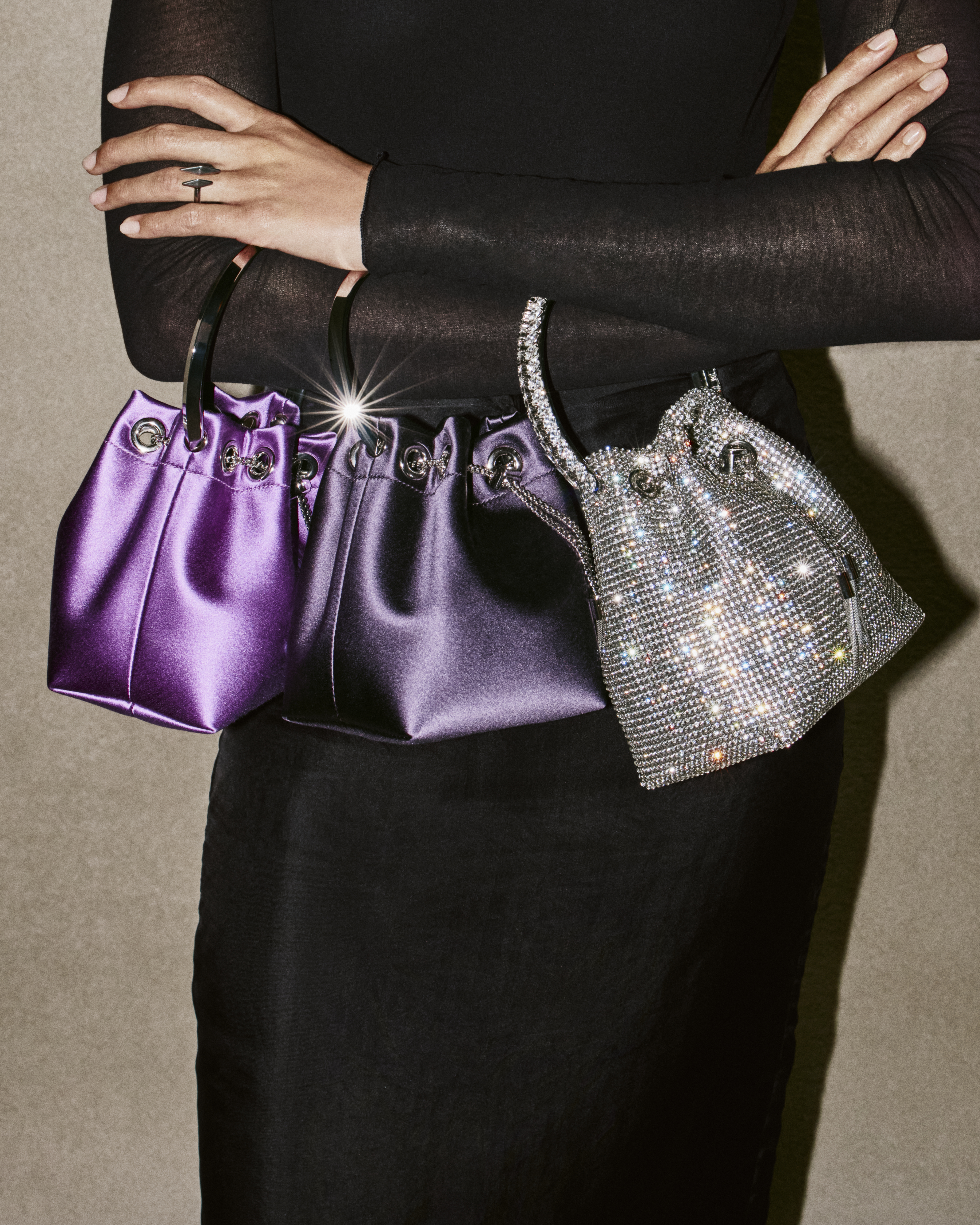 a model carrying three jimmy choo party bags