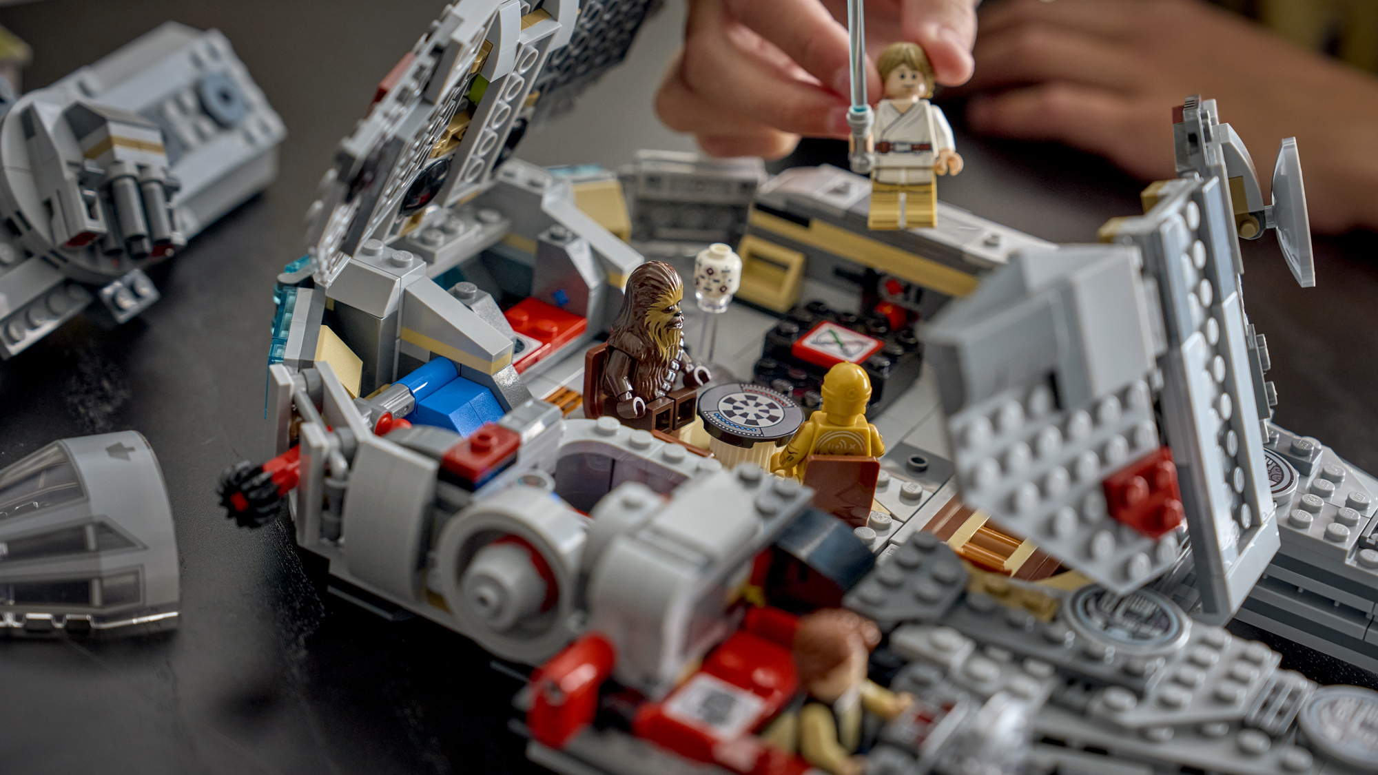 A Lego Smart Play Millennium Falcon with its roof open.