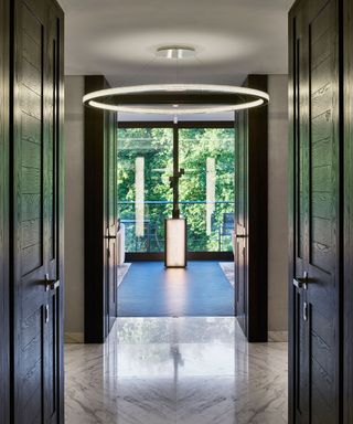 Entryway with stone slab floor and black woodwork