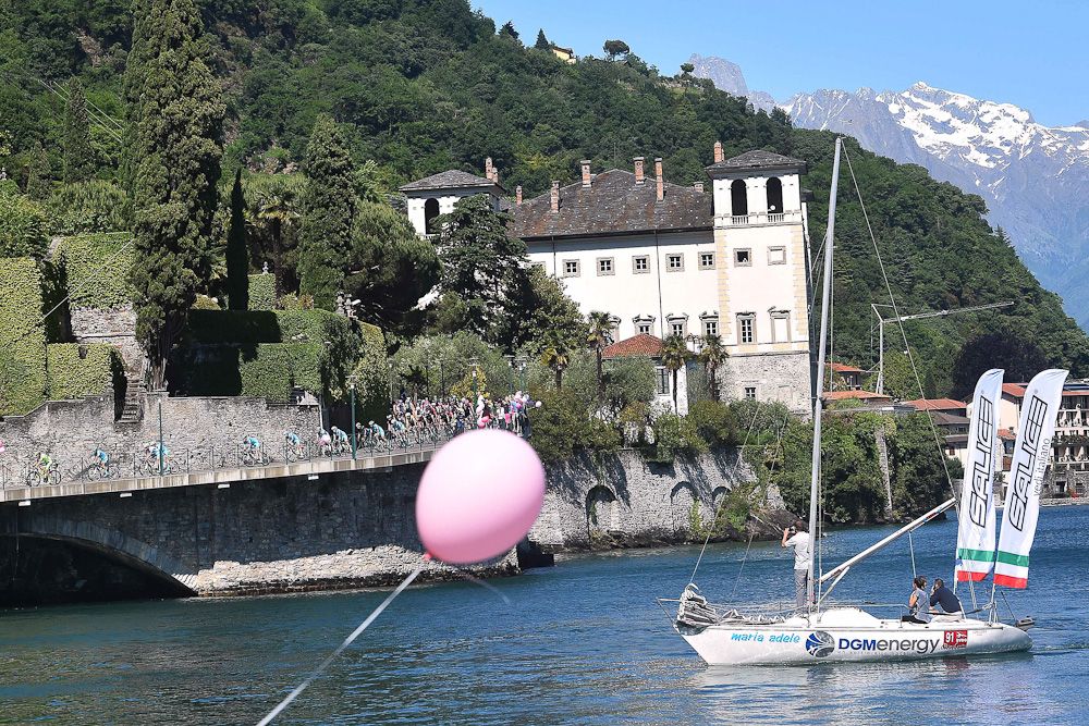 The peloton passes some sailboats during stage 17.