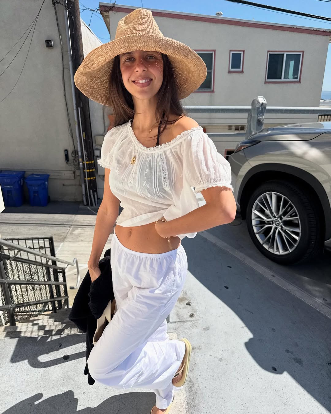 Gabri Gofis wearing a white embroidered Doen top