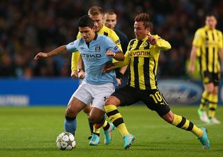 Sergio Aguero of Manchester City competes with Mario Gotze of Borussia Dortmund during the UEFA Champions League Group D match between Manchester City and Borussia Dortmund at the Etihad Stadium on October 3, 2012 in Manchester, England.