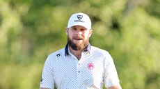 Tyrrell Hatton looks on while wearing a white Topgolf cap during round two of The Masters in 2025