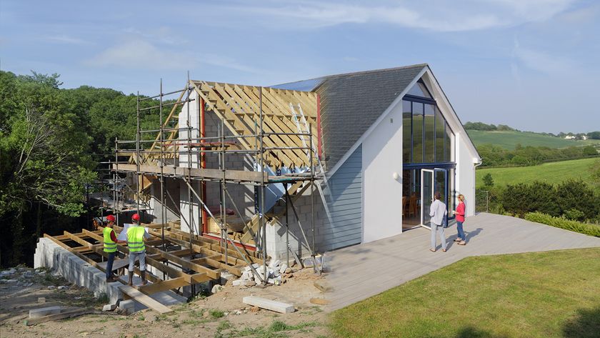 A house being newly renovated with scaffolding on the side constructing a new roof