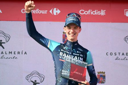 Jakob Omrzel holds his fist up on the podium after winning stage 12 of the 2026 Vuelta a Espana