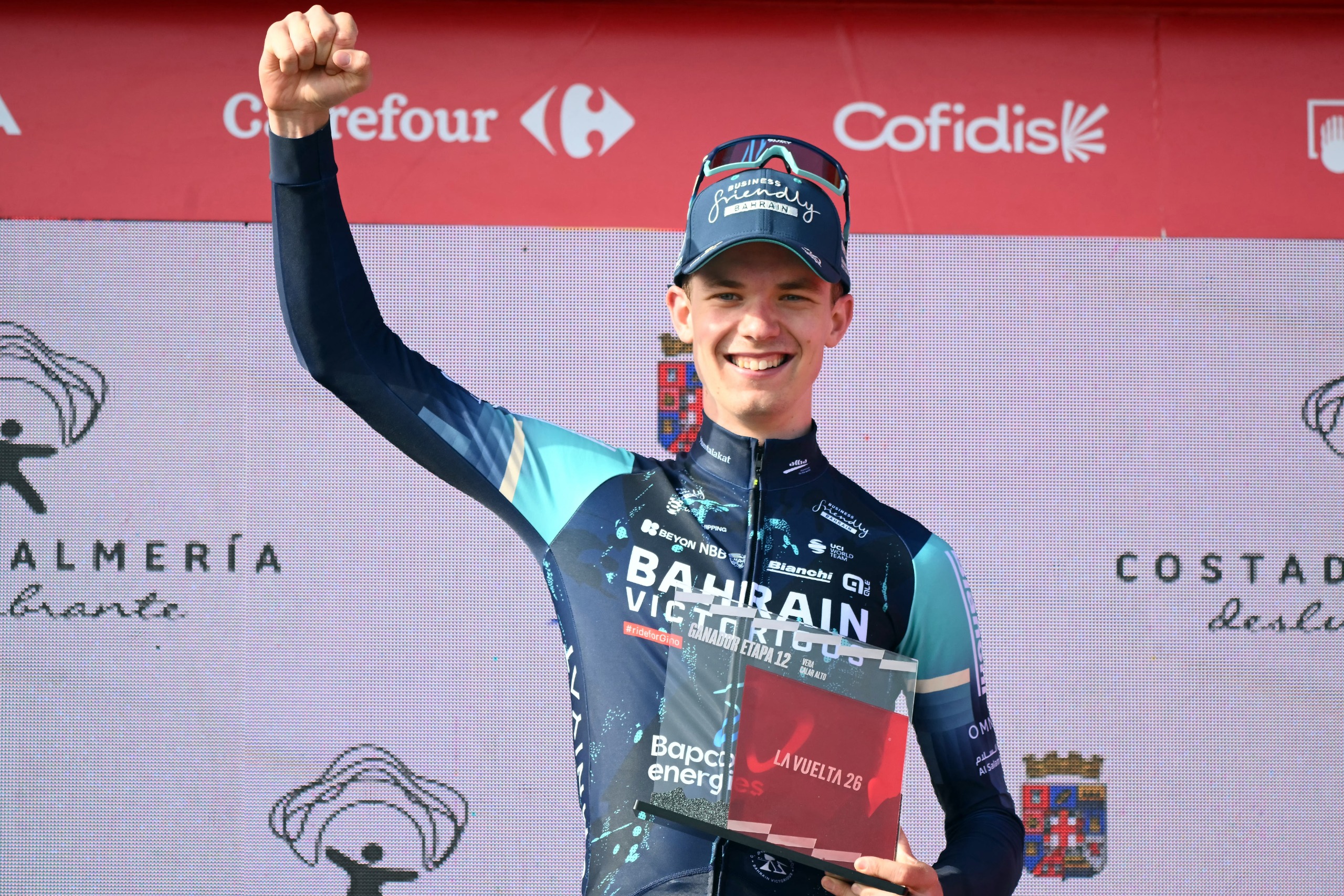 Jakob Omrzel holds his fist up on the podium after winning stage 12 of the 2026 Vuelta a Espana