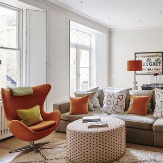 living room with white walls round table and sofa sets