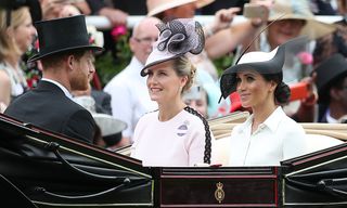 Prince Harry, Duke of Sussex, (L) and his wife Britain's Meghan, Duchess of Sussex (R) arrive with Britain's Sophie, Countess of Wessex, on day one of the Royal Ascot horse racing meet, in Ascot, west of London, on June 19, 2018