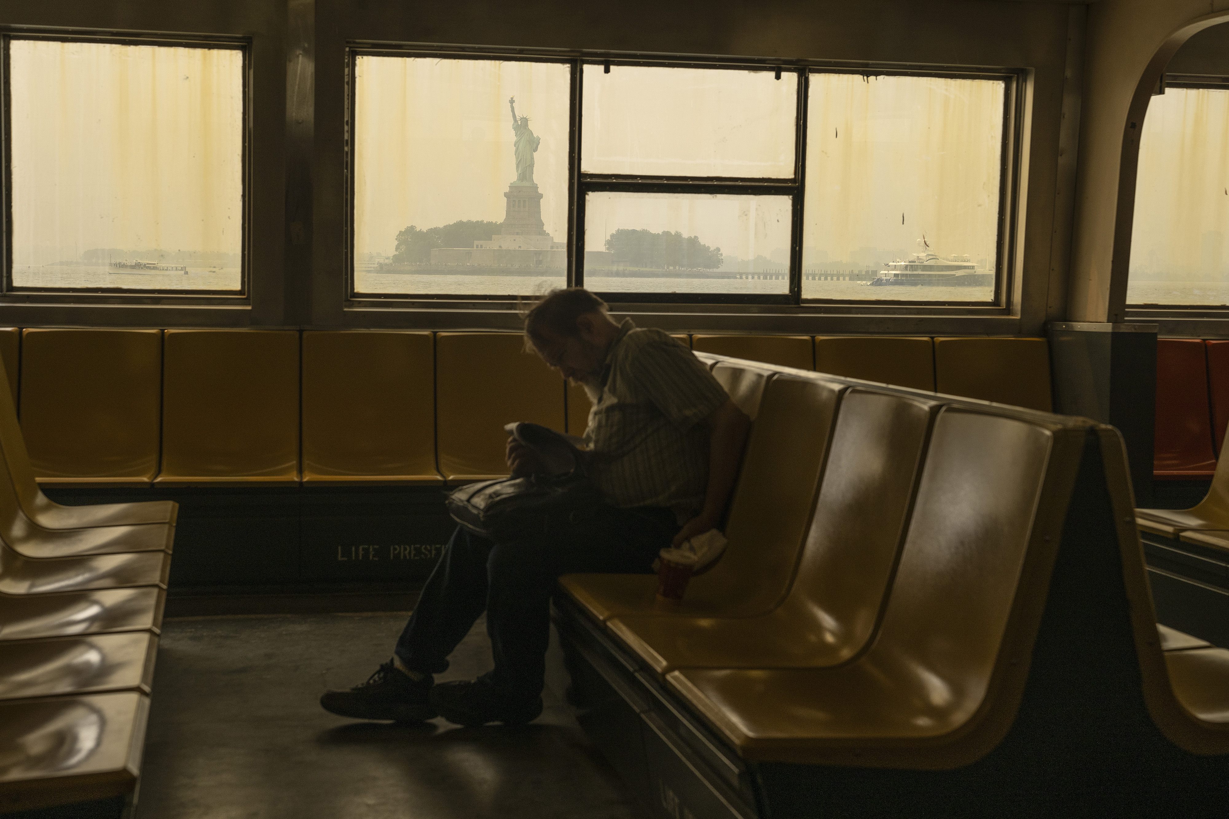 NEW YORK, NEW YORK - JULY 16: Haze from Canadian wildfires blankets the Statue of Liberty as seen from a Staten Island Ferry on July 16, 2026 in New York City. Much of the East Coast and Canada is under an Air Quality Health Advisory as the Canadian and Great Lakes wildfire smoke gradually moves through the area, creating a thick haze in the heat. The region is experiencing temperatures with heat indexes over 100 degrees as it confronts another heat wave. (Photo by David Ramos/Getty Images)