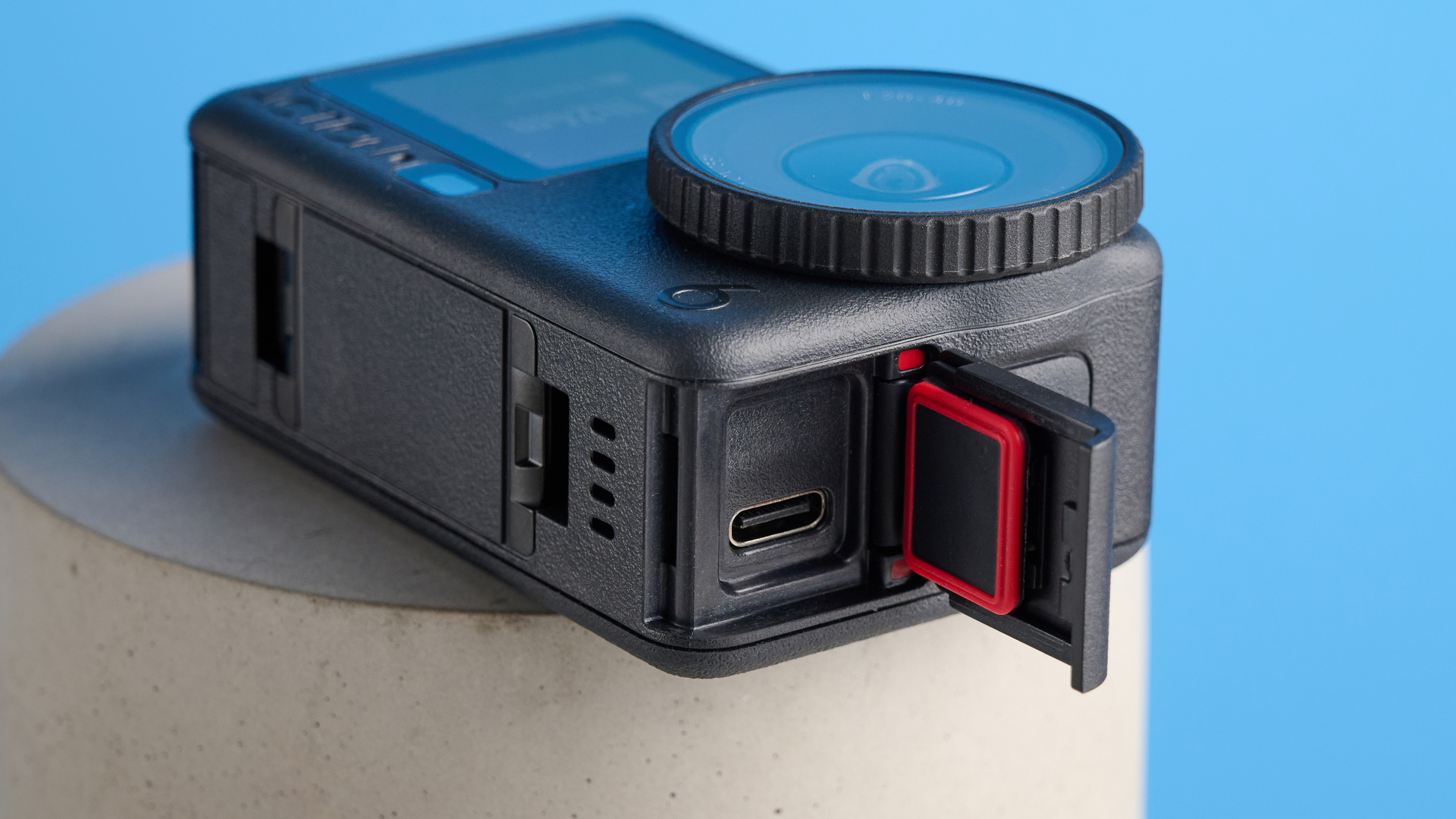 The DJI Osmo Action 6 on a stone surface with a blue background