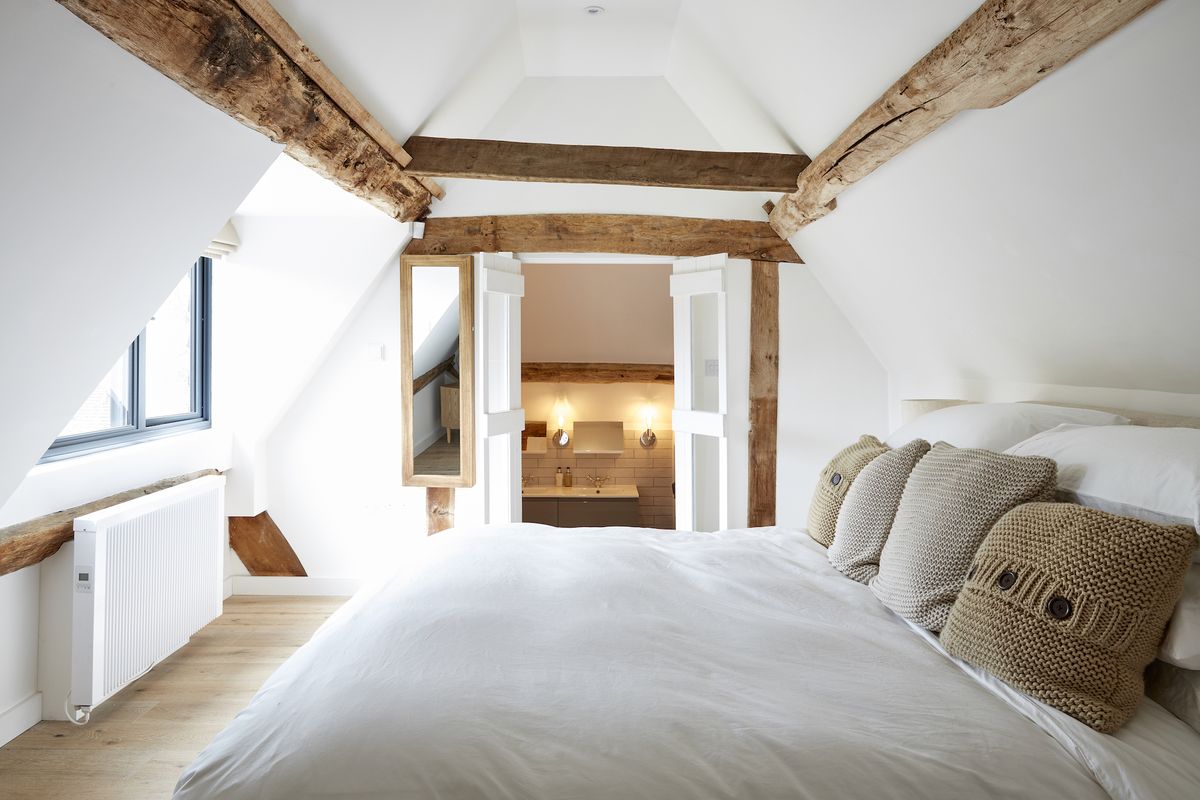 white bedroom with view to small en suite