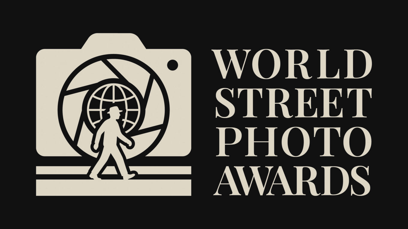 Logo of the World Street Photo Awards featuring a camera silhouette, a globe, and a walking figure, all against a black background