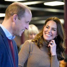 Prince William and Kate Middleton, now Prince and Princess of Wales, smile during a visit to the Church on the Street in Burnley in 2022