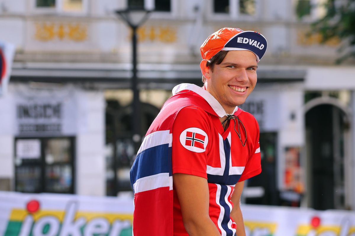 A fan smiles while watching the race