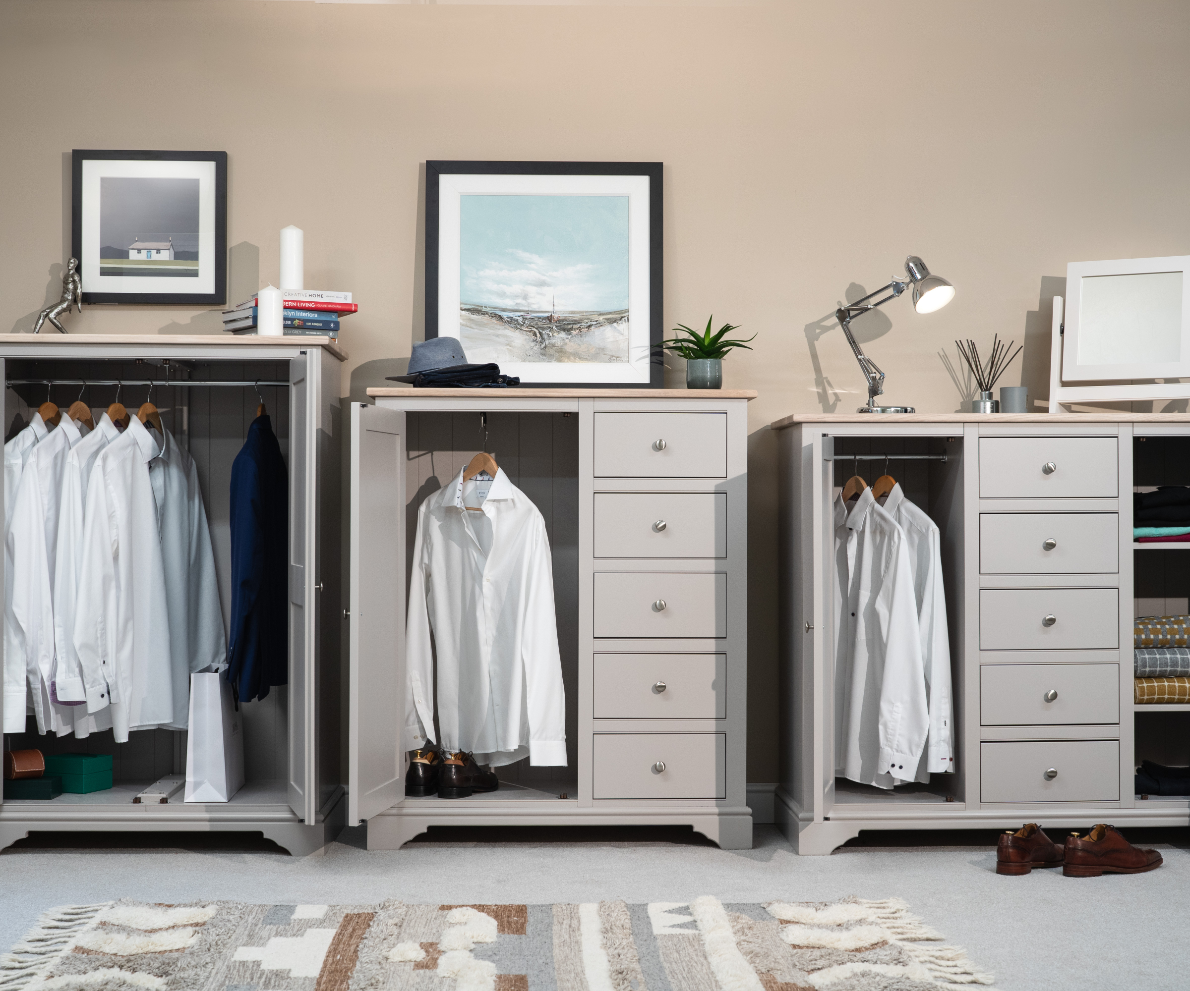 three gentleman's chest wardrobes in grey with clothes inside