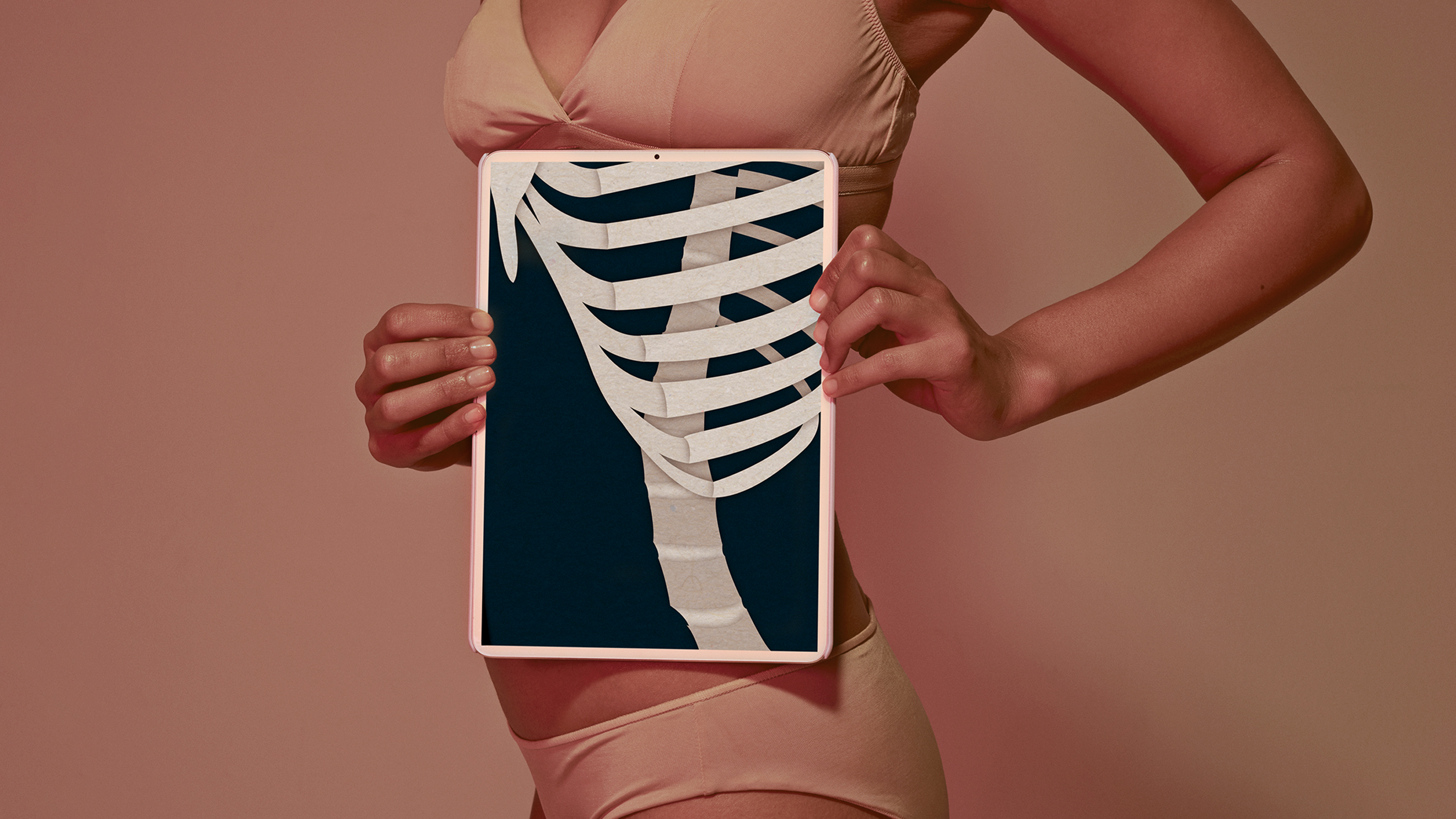 a design featuring a woman wearing undergarments and holding an x ray of a skeleton to her ribcage