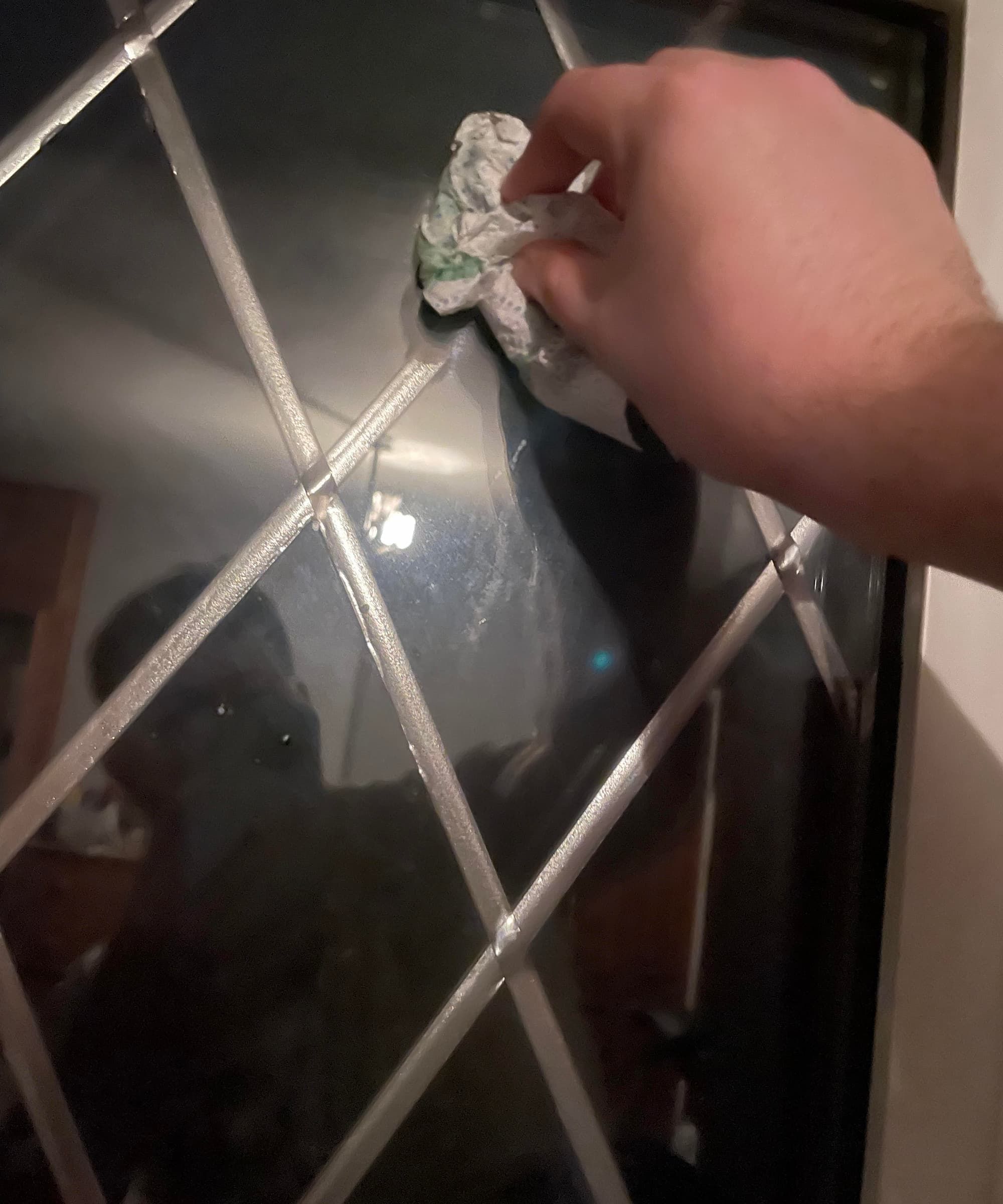 Washing-up liquid being wiped on a window